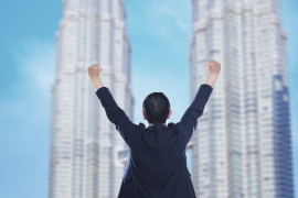 business-success-celebrating-business-man-overlooking-the-city-center-high-rises-SBI-301985214